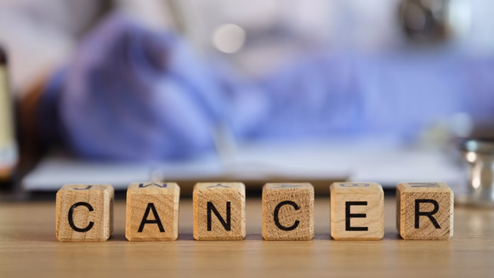 Doctor,Filling,Out,Medical,Paperwork,On,Background,Of,Wooden,Cubes
